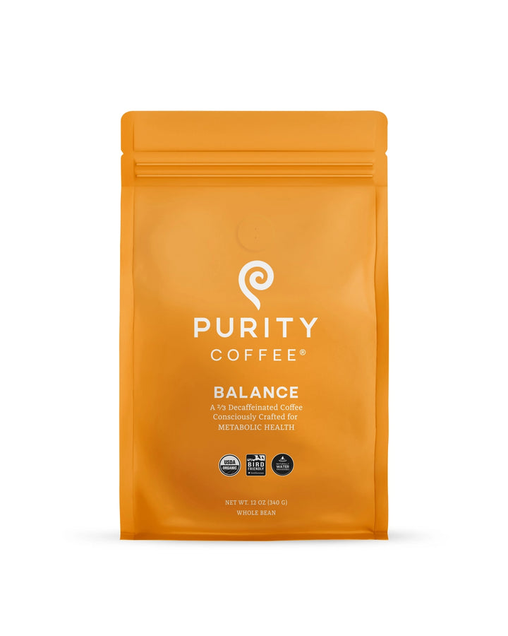 Orange coffee package labeled 'Purity Coffee Balance' on a white background